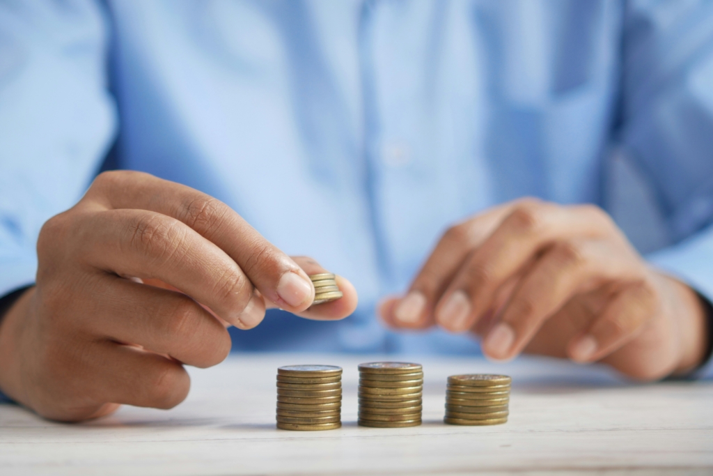 Two hands stacking coins